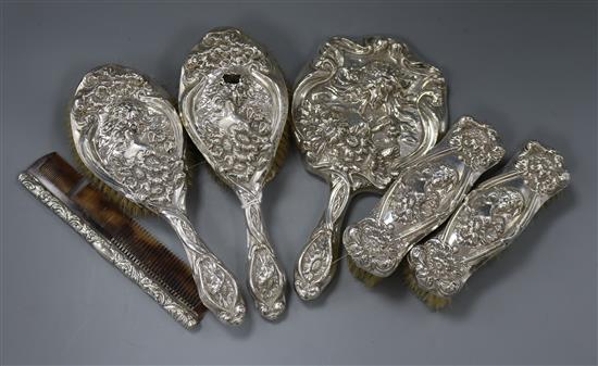 An Edwardian five piece embossed silver mounted dressing table set by Levi & Salaman and a similar mounted comb.
